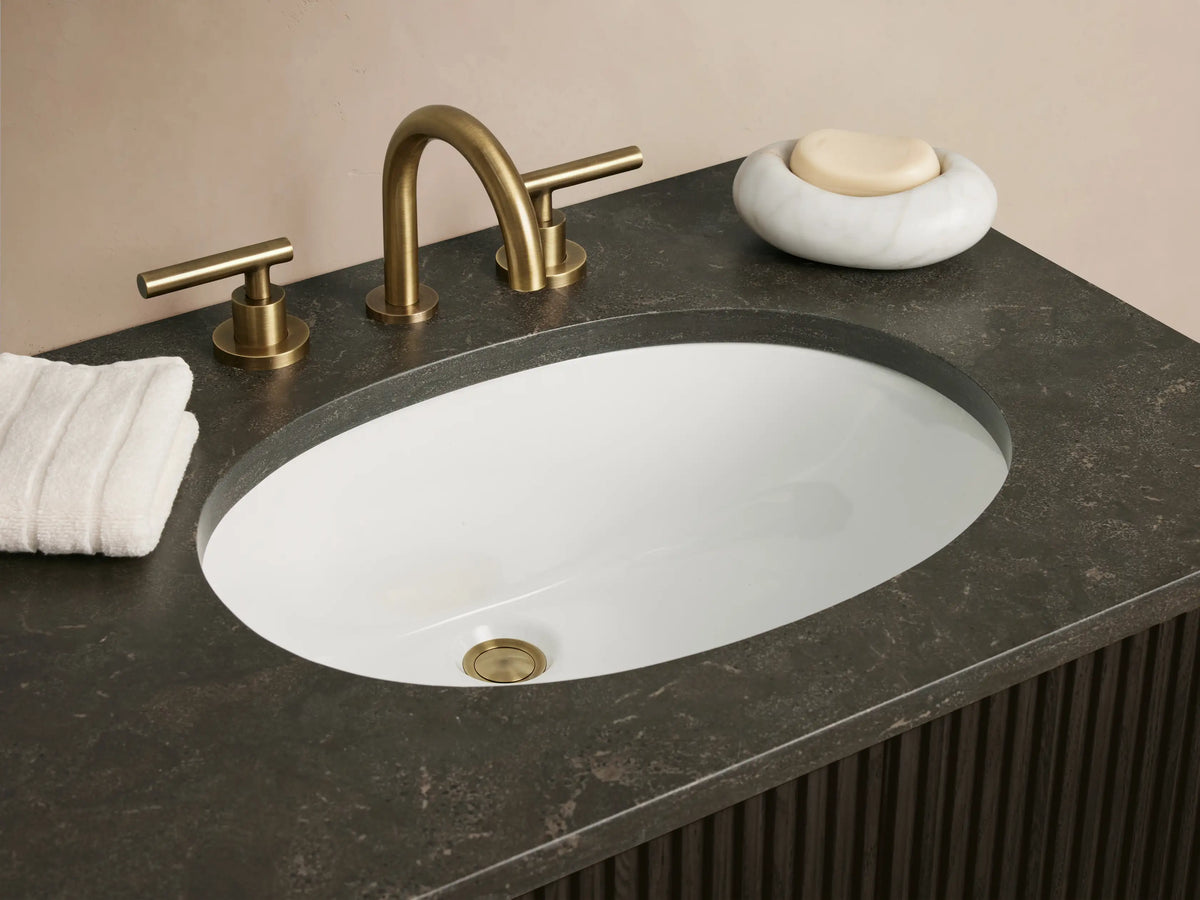 Finnley Wide Single Vanity, dark brown slatted, dark gray top, with 2 oval white sinks, brass bar pulls.