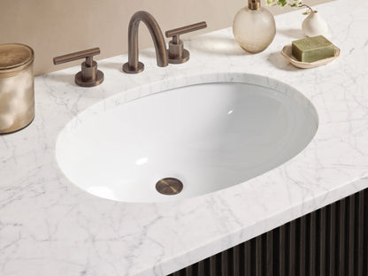 Finnley Wide Single Vanity: Dark fluted wood cabinet with white marble top, oval sink, and bronze bar handles, centered in a room.
