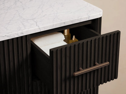 Close-up of Finnley Wide Single Vanity's white marble countertop with an oval sink, three faucet holes, and dark slatted base.