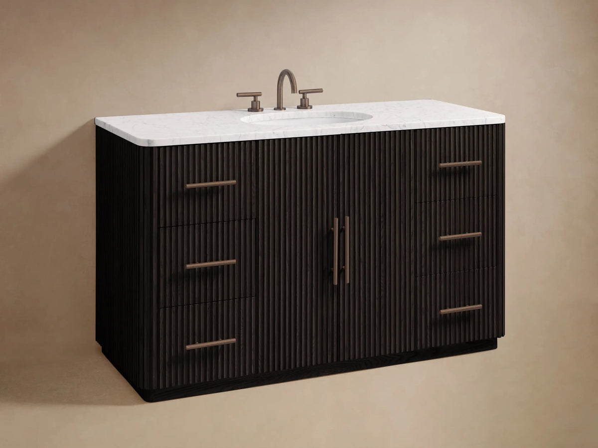 Close-up of Finnley Wide Single Vanity's dark fluted wood doors with antique bronze bar pulls. One door slightly open, revealing shelves.