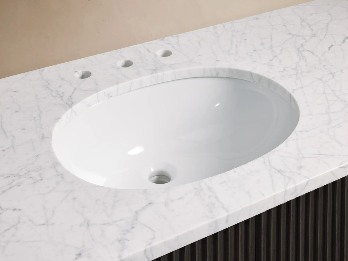 Finnley Single Wide Vanity with oval ceramic sink set in marble top, featuring antique brass faucet and soap dish.