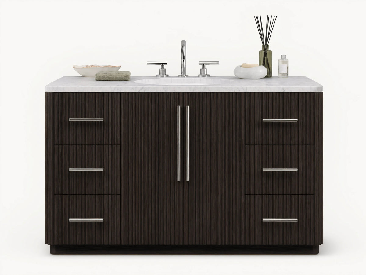 The image shows the Finnley Single Wide Vanity with a dark oak finish. It has a white stone top and an oval ceramic sink, with silver hardware on six drawers and two central doors.