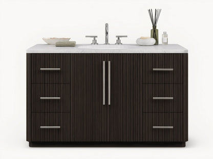 The image shows the Finnley Single Wide Vanity with a dark oak finish. It has a white stone top and an oval ceramic sink, with silver hardware on six drawers and two central doors.