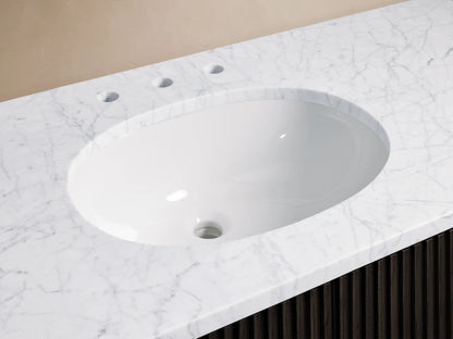 Finnley Single Wide Vanity with marble countertop, oval ceramic sink, and polished nickel faucet, featuring soft-white hues and natural patterns.