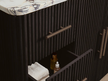 Close-up, top-down view of Finnley Wide Single Vanity. White marble top with prominent reddish-brown veining, oval white sink, 3 faucet holes.