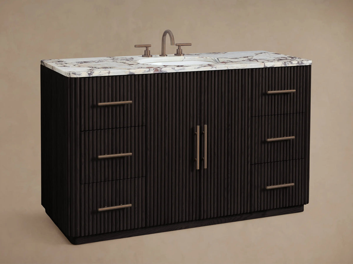 Finnley Wide Single Vanity close-up: white oval sink, antique bronze faucet, Calacatta Viola marble top with dark veining.