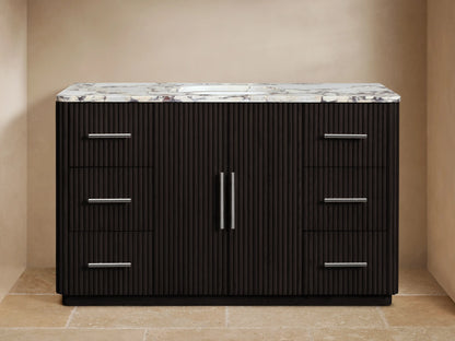 Finnley Wide Single Vanity, dark fluted wood with white veined marble top, polished nickel hardware & sink, in bathroom.