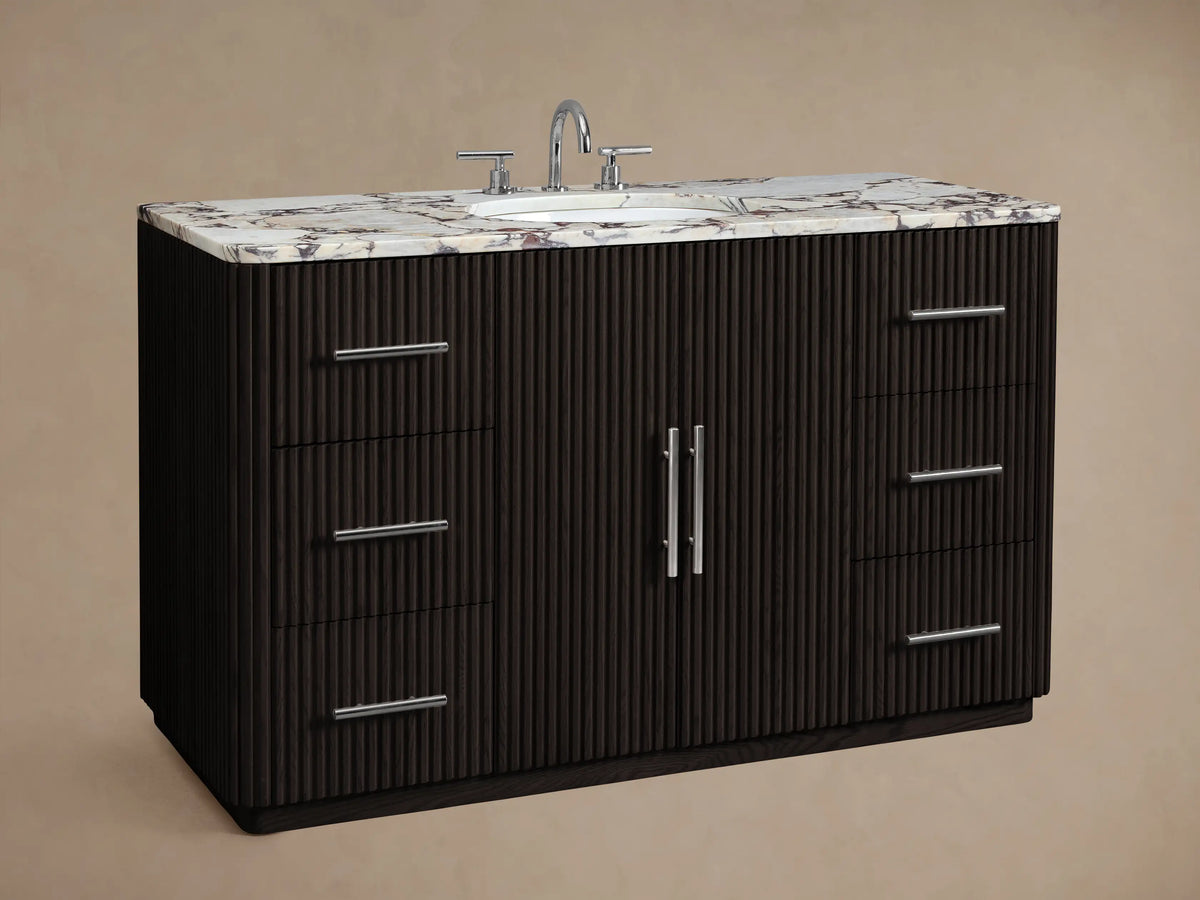 Finnley Wide Single Vanity: Dark brown ribbed wood, white veined marble top, polished nickel hardware, 2 doors, 6 drawers.