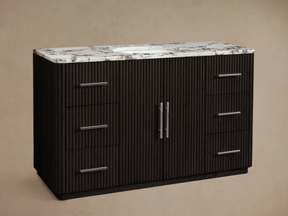 Finnley Wide Single Vanity: Dark fluted wood, white Carrara marble top, oval sink, chrome faucet, six chrome pulls.