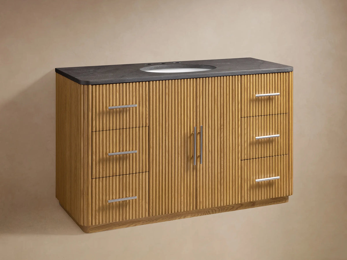 Finnley Single Wide Vanity with oak wood and vertical grooves, featuring a stone top and oval sink with chrome faucet hardware.