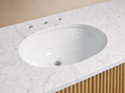 Close-up of Finnley Wide Single Vanity with oval white sink, white marble countertop, antique bronze faucet, and slatted wood.