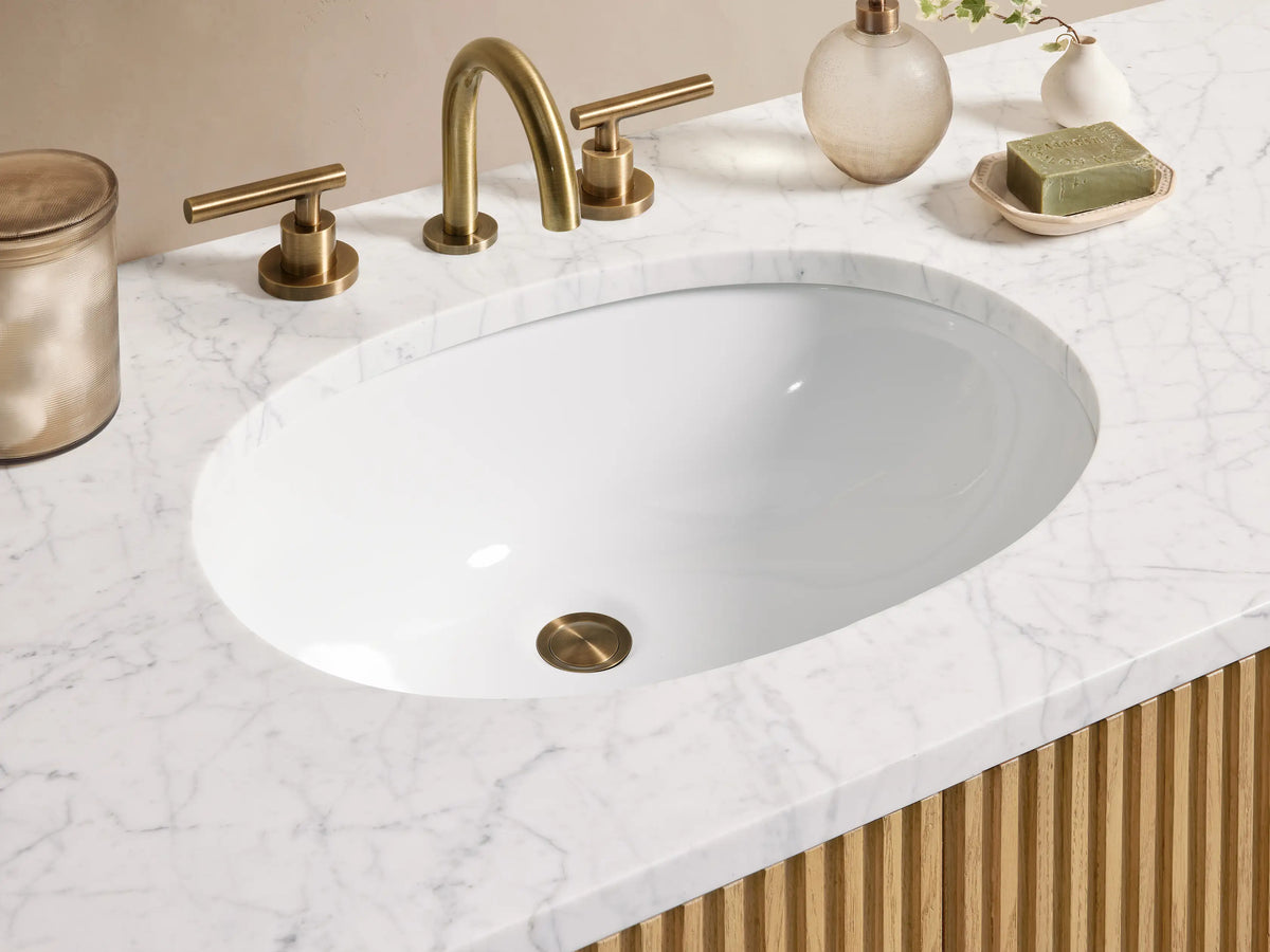 Finnley Single Wide Vanity with ribbed oak wood design, six drawers, central double doors, stone top, and brass hardware.