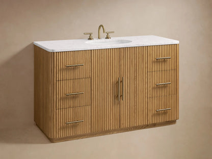 Finnley Single Wide Vanity features ribbed oak wood doors with brass handles, open to show shelves with towels and a box.