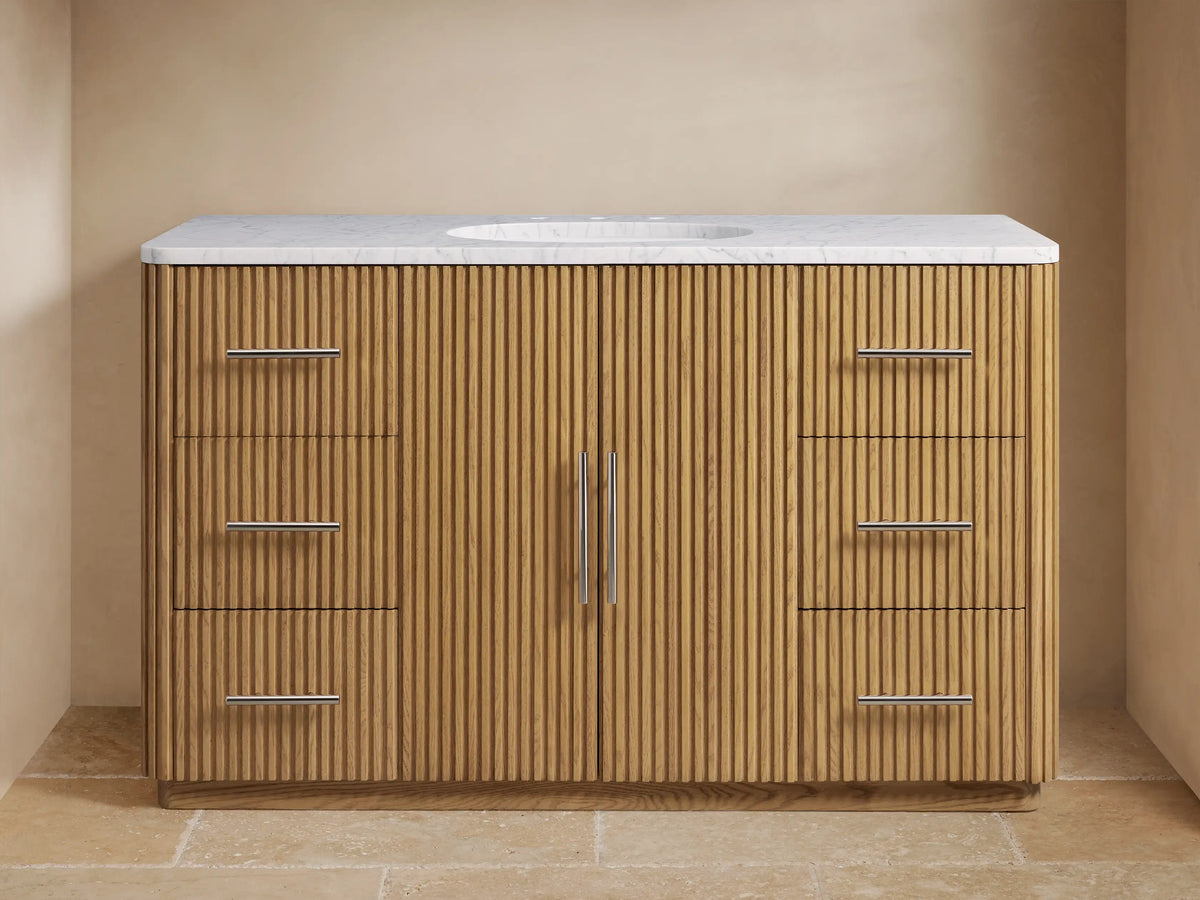 Finnley Single Wide Vanity with oak wood slatted front, polished nickel hardware, Carrara marble top, and oval ceramic sink.
