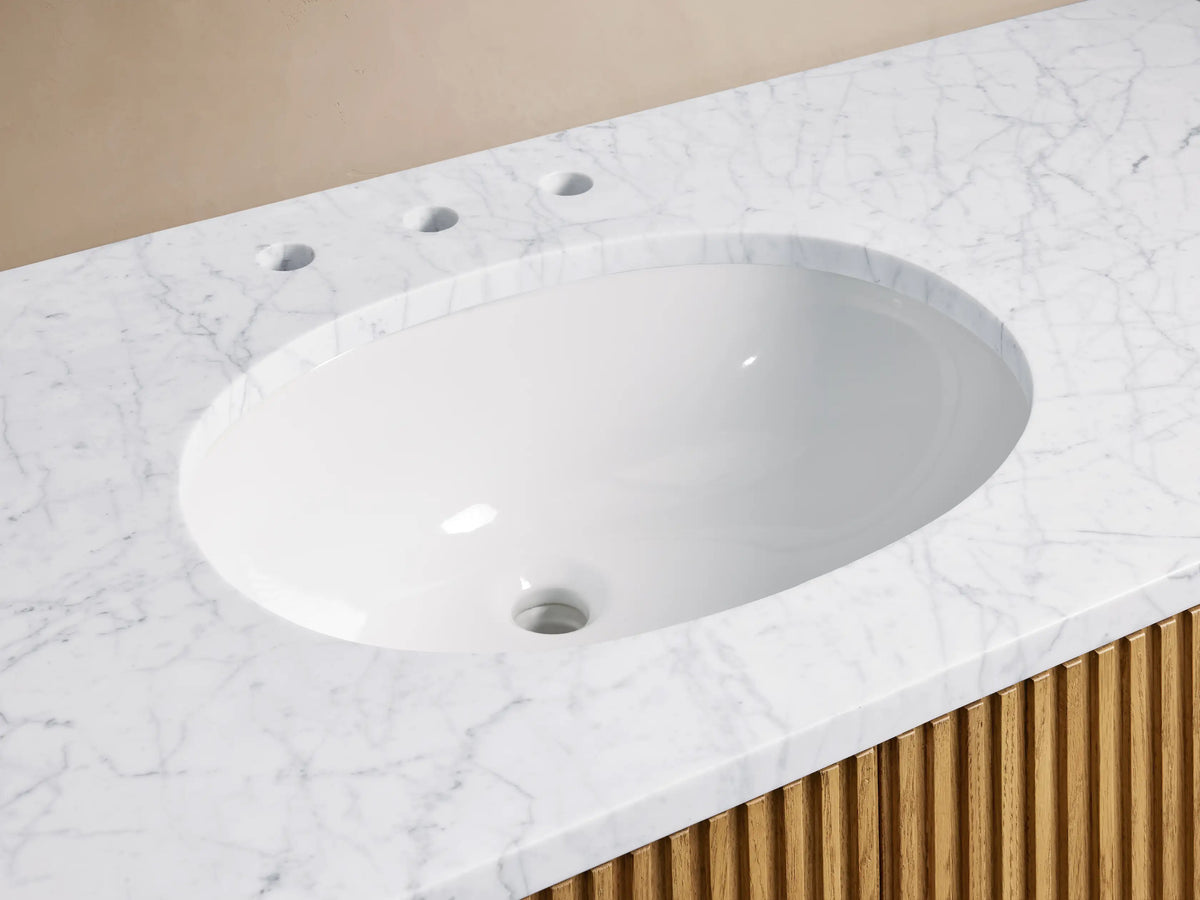 Finnley Single Wide Vanity with white Carrara marble top, oval ceramic sink, and polished nickel faucets. Vertical slat wood finish below.