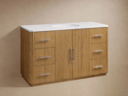 Finnley Single Wide Vanity with ribbed oak wood finish, featuring two central doors and six drawers with polished nickel handles, topped with white marble and a ceramic sink.
