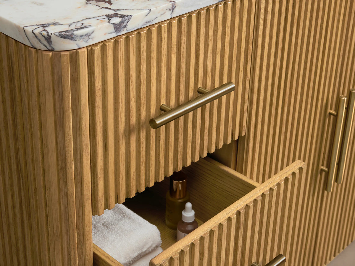 Close-up of Finnley Wide Single Vanity's white oval sink set in a veined marble top with 3 faucet holes & grooved wood base.