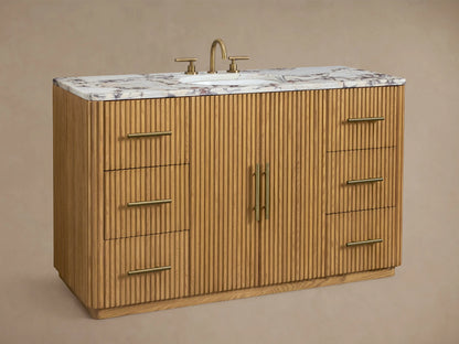 Finnley Wide Single Vanity, close-up of light oak fluted door with brass handle, slightly open, revealing white towels on a shelf.