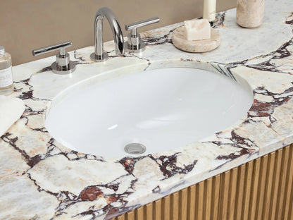Finnley Wide Single Vanity, light oak with fluted texture, white marble top, oval undermount sink, silver bar pulls, slightly angled.