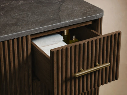 Finnley Wide Single Vanity: White oval undermount sink, dark gray textured countertop with 3 faucet holes, and wood slat base.