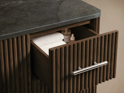 Close-up of Finnley Wide Single Vanity with white oval ceramic sink, dark gray stone top, faucet holes, and slatted wood base.