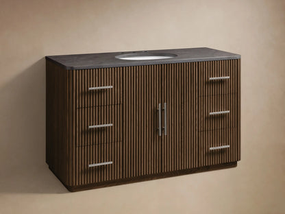 Finnley Wide Single Vanity with dark grey stone top, oval white sink, silver faucet. Dark fluted wood base, 2 doors, 6 drawers.