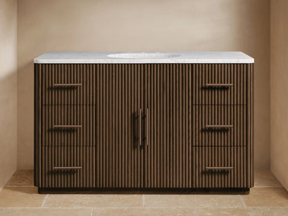 Dark brown Finnley Wide Single Vanity with reeded wood front, white marble top, oval sink, bronze faucet, and accessories.