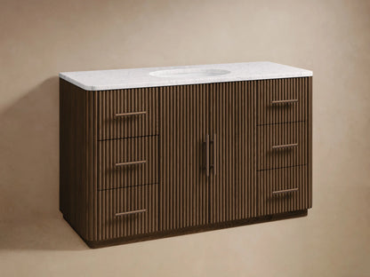 Finnley Wide Single Vanity: dark brown fluted wood, white marble top with oval sink & dark faucet, six drawers, two doors.