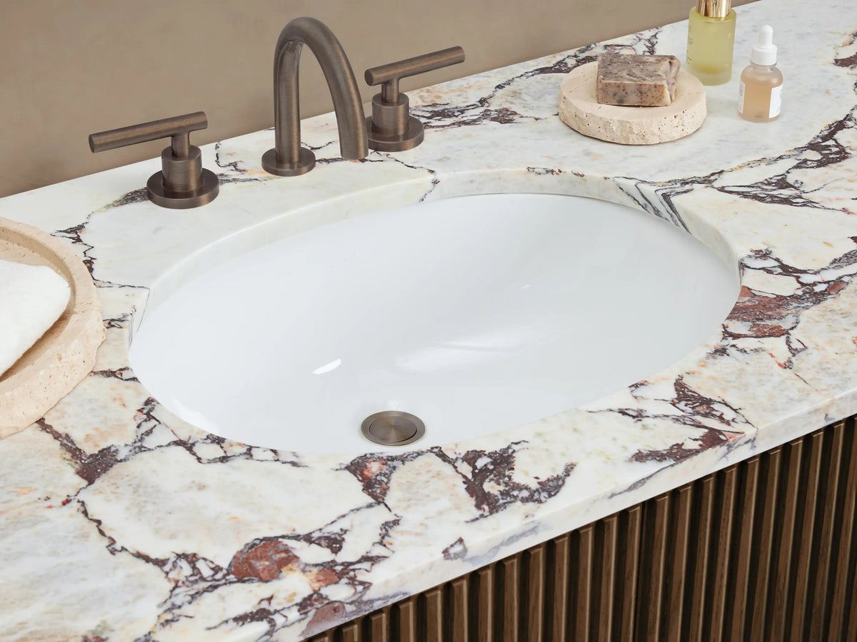 Finnley Wide Single Vanity, dark brown ribbed wood with white/reddish-brown marble top, oval sink, 6 drawers, and dark handles.