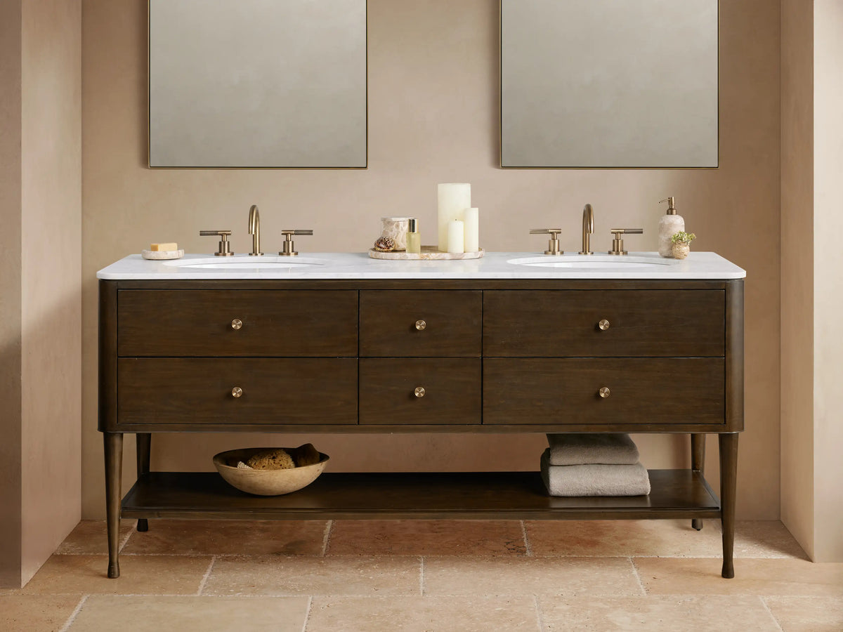 Laurent Double Vanity: dark brown wood with white marble top, two sinks, bronze faucets, six drawers, and open shelf.