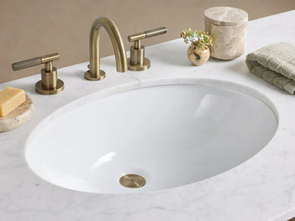 Laurent Double Vanity: Bahasa Brown cherry wood, white marble double sink top, six drawers with brass knobs, & open lower shelf.