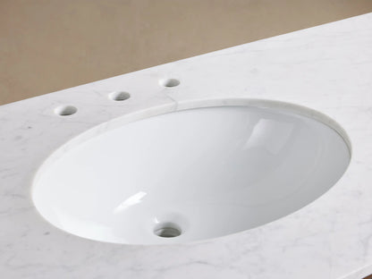 Close-up of Laurent Double Vanity's white oval undermount sink, set in veined white marble with a brass widespread faucet.