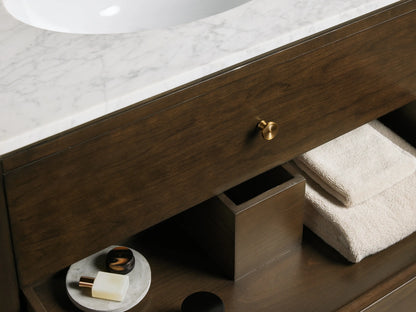 Close-up of Laurent Single Vanity. White oval ceramic sink in veined white Carrara marble top with three faucet holes.