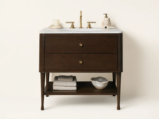 Laurent Single Vanity: Dark brown wood, white marble top, oval sink, brass hardware, open shelf with towels, bathroom setting.