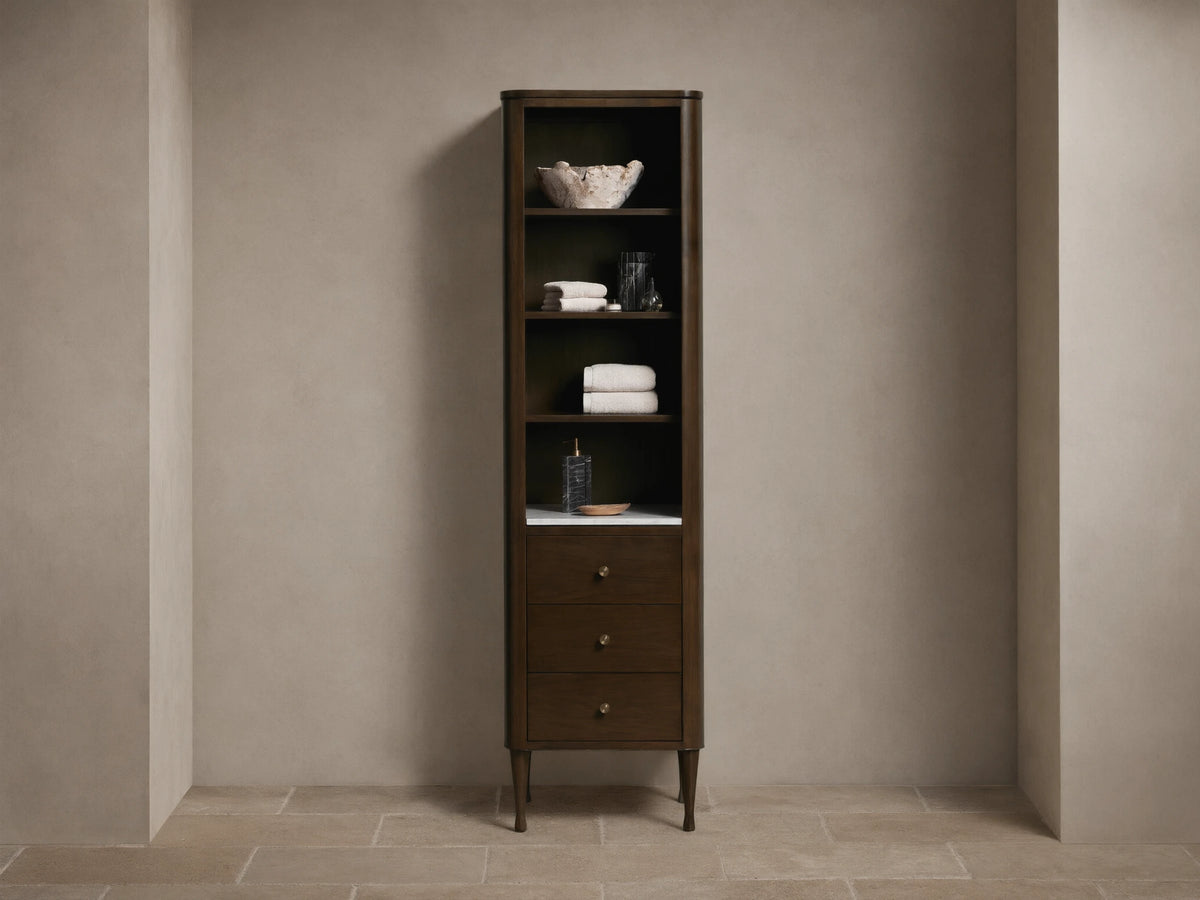 Tall Laurent Bath Cabinet, dark wood, white marble, 4 shelves with towels & decor, 3 drawers, brass pulls.