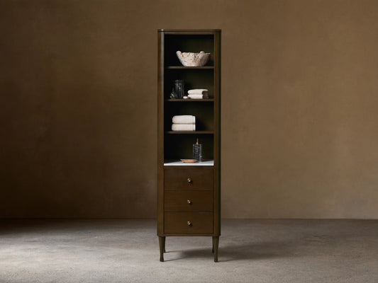 Tall Laurent Bath Cabinet, dark wood, white marble, 4 shelves with towels & decor, 3 drawers, brass pulls.