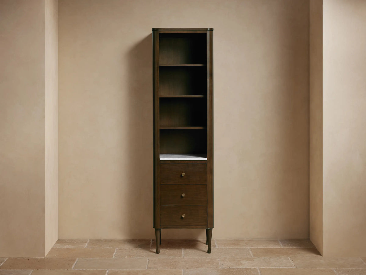 Tall Laurent Bath Cabinet, dark wood, white marble, 4 shelves with towels & decor, 3 drawers, brass pulls.