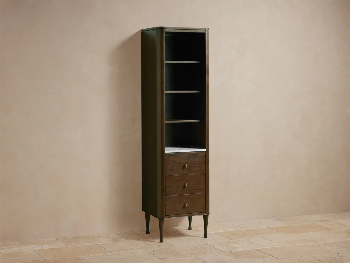 Close-up of Laurent Tall Bath Cabinet interior with dark brown wood shelves and white Carrara marble bottom.