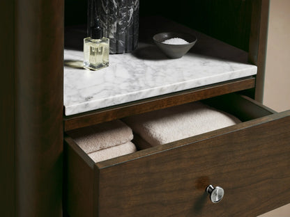 Laurent Tall Bath Cabinet: Bahasa Brown cherry wood, 3 open shelves, white marble top, 3 drawers with silver knobs.