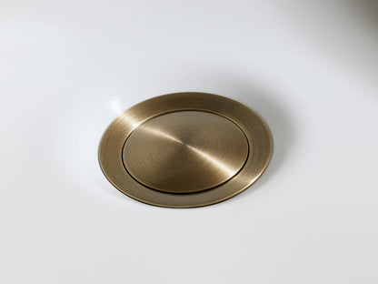 Lomas Faucet in antique brass finish, featuring a cross-styled handle on a round base, displayed on a marble surface.