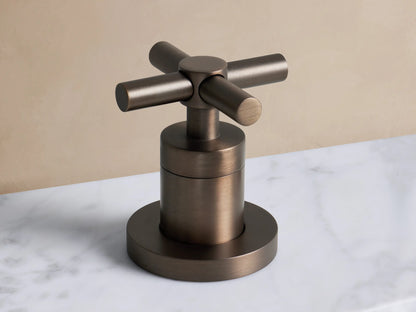 Lomas Faucet in Antique Bronze finish, featuring two cross-styled handles on a white marble vanity with an oval sink.