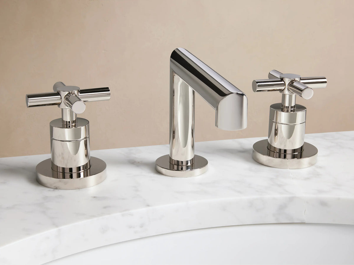 Lomas Faucet with polished nickel finish, featuring a central spout and two cross-styled handles on a white countertop.