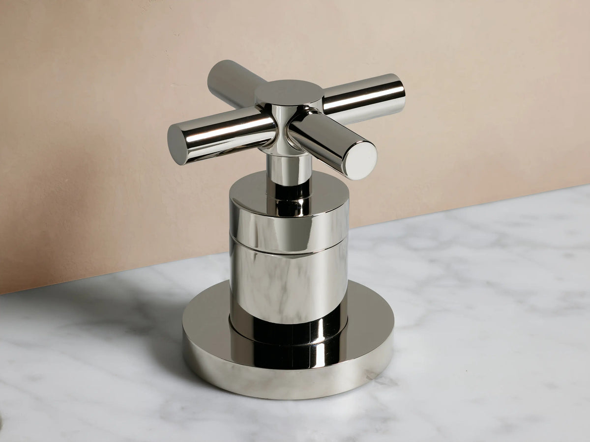 Lomas Faucet with polished nickel finish, featuring a central spout and two cross-styled handles on a white countertop.