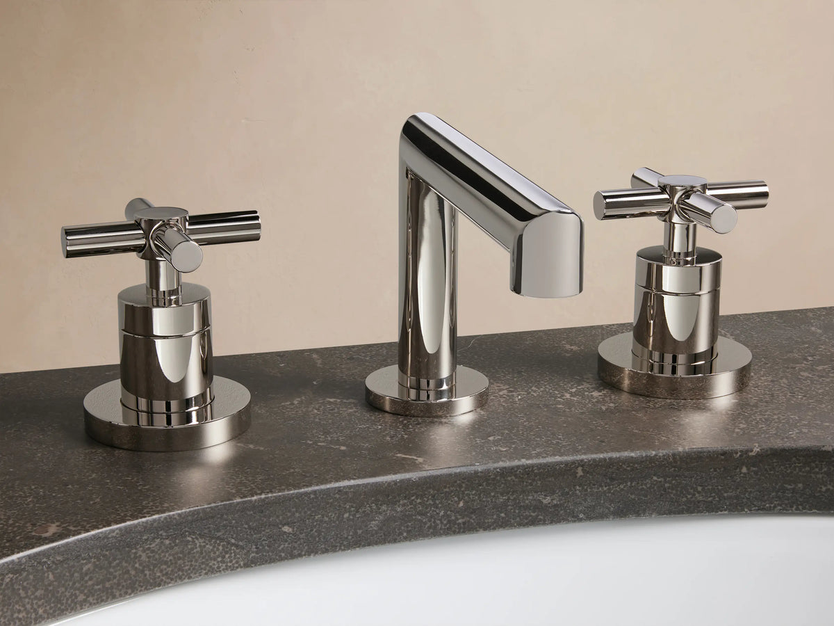 Lomas Faucet with a polished nickel finish on a marble countertop, featuring two cross-styled handles and a matching pop-up drain.