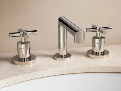 Lomas Faucet featuring polished nickel finish with a central spout and two cross-styled handles on a marble countertop.