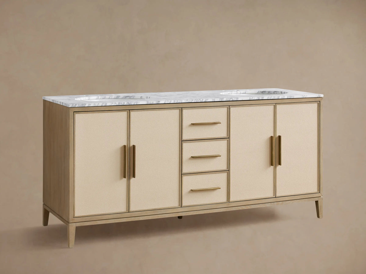 Malone Double Vanity: light oak finish, white marble top, 2 sinks, brass faucets, 3 drawers, and 4 cabinet doors with cream panels.