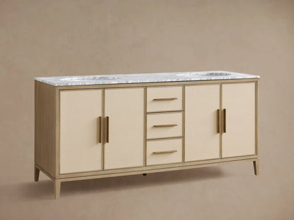 Malone Double Vanity: light oak finish, white marble top, 2 sinks, brass faucets, 3 drawers, and 4 cabinet doors with cream panels.