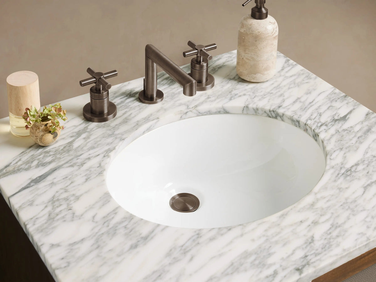Malone Powder Vanity: Dark wood vanity with grey shagreen-textured doors, white marble top, integrated sink, and dark pull handles.