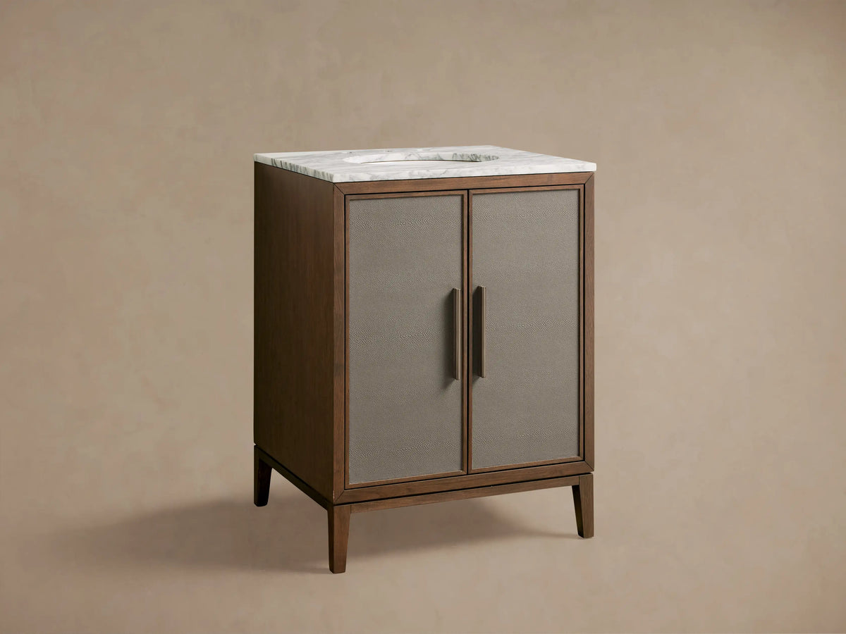 Malone Powder Vanity: dark walnut wood with white marble top, ceramic sink, bronze faucet, and two grey textured doors.