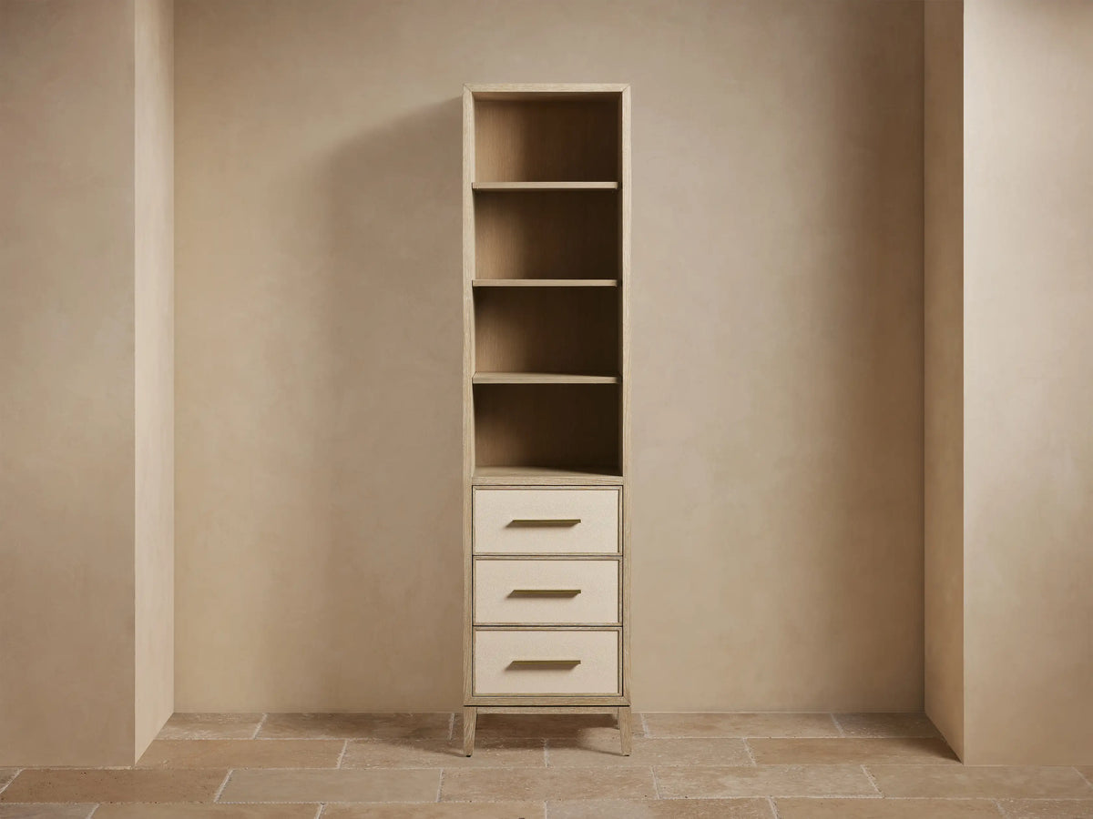 Tall Malone Bath Cabinet, bone finish oak. Open shelves hold towels & decor; 3 drawers have light faux shagreen fronts.